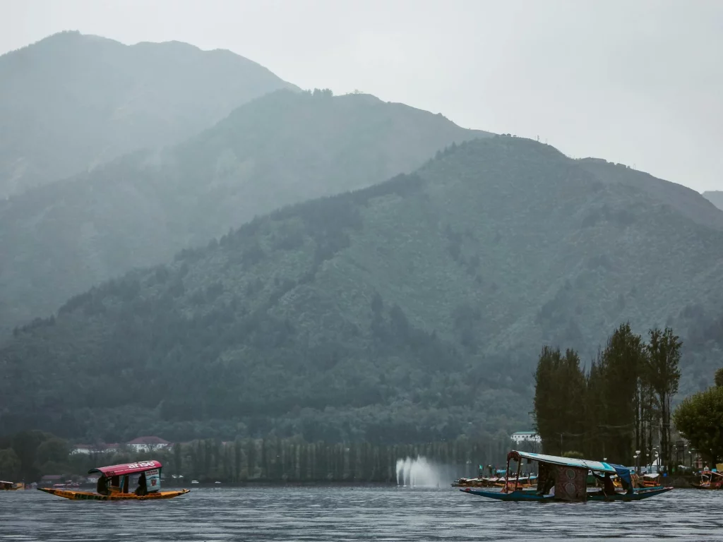 boat in Kashmir lake surrounded by mountains