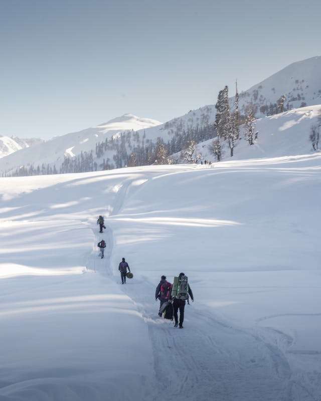 people doing adventure in Kashmir. trekking snowing mountain in Kashmir