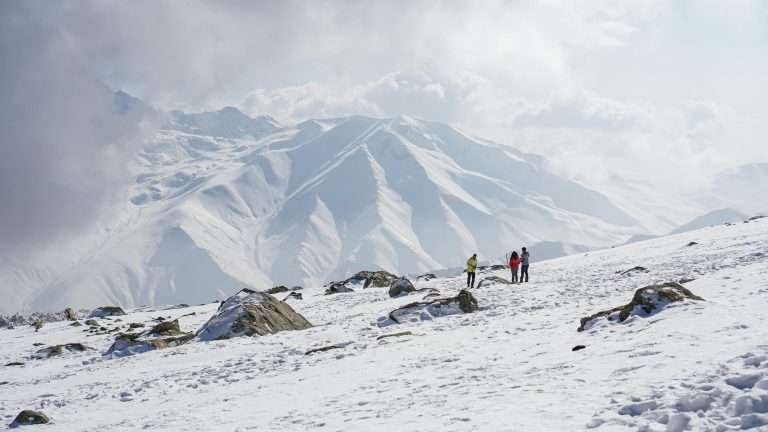 people in kashmir on snowy mountain at the best time to visit kashmir